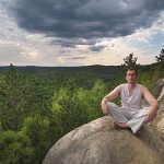 Young man meditating in the nature, Algonquin, Ontario, Canada