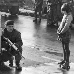 #14 Young Girl With Roller Skates Shows A Soldier In Derry She Isn’t Scared, Northern Ireland, 1969