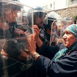 #33 A Woman Gestures To Riot Policemen During A Protest Organized By The Rally For Culture And Democracy (Rcd), Algiers, 02 July