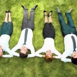 it-people-relaxing-on-grass